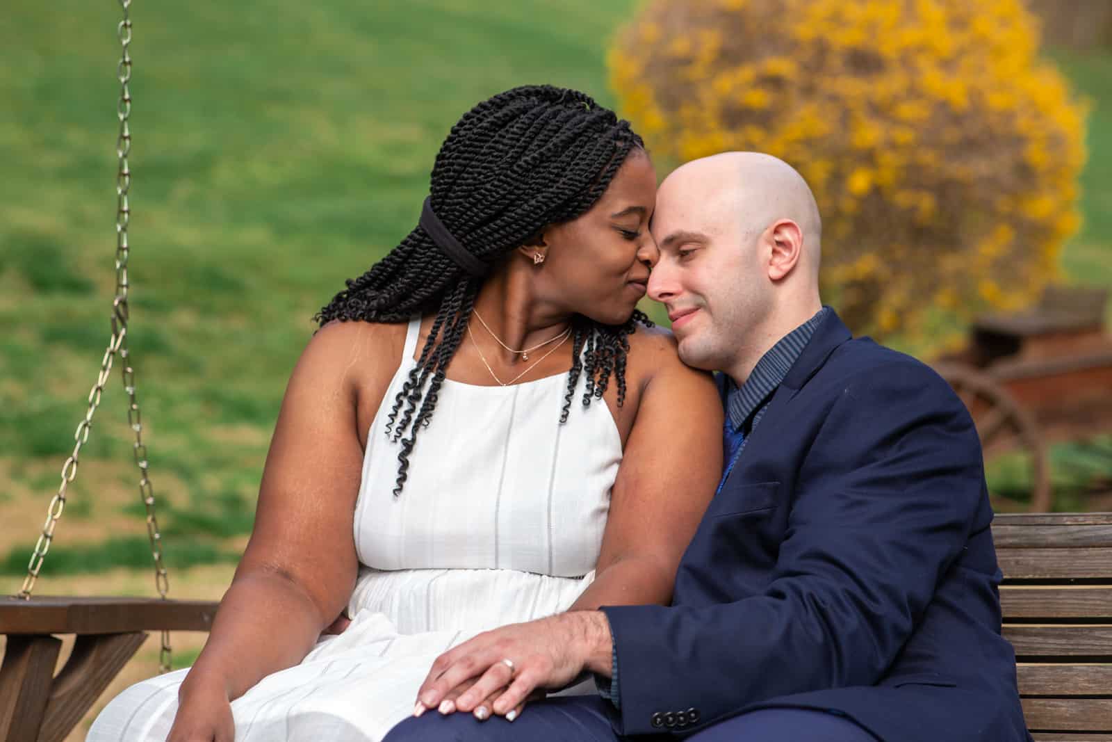 Spring Nashville Elopement at Butterfly Hollow; bride and groom cuddle together on outdoor wooden swing